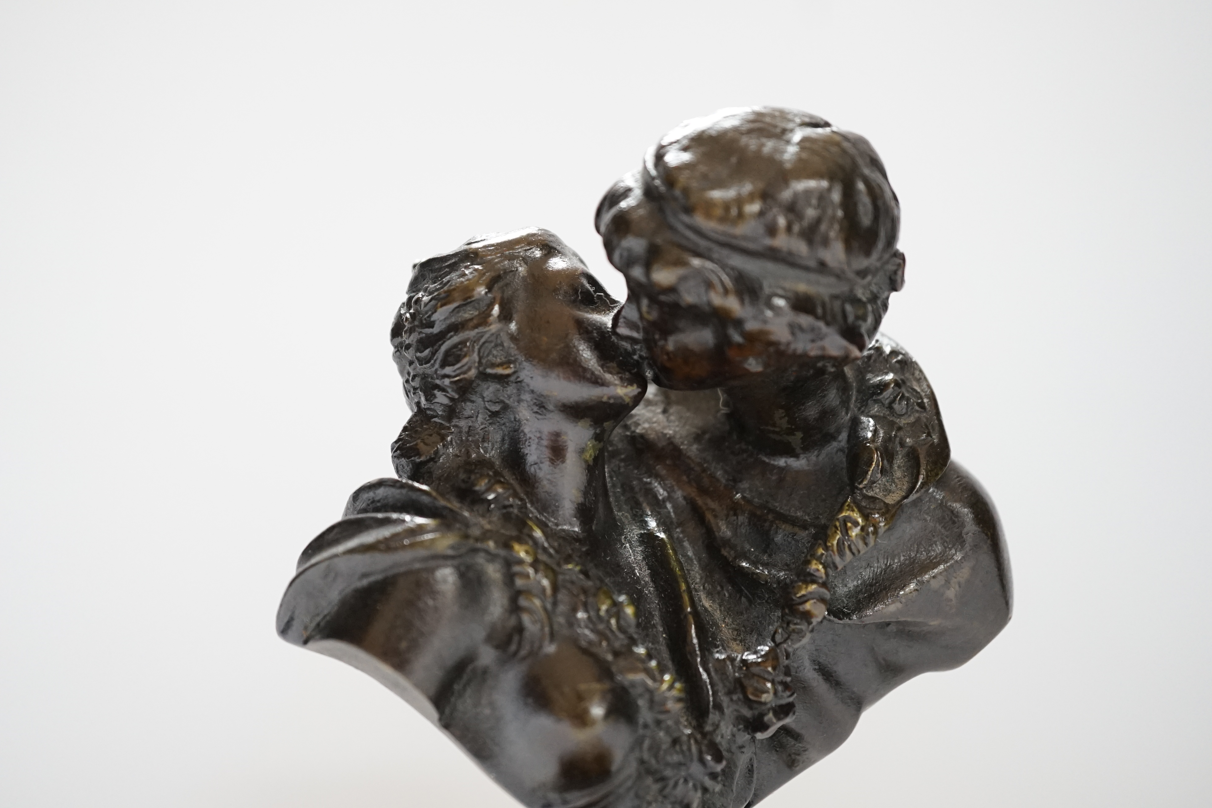 After Jean-Antoine Houdon (1741-1828), a bronze group, 'Le Baiser Donne' [‘The Kiss Bestowed’] on marble base, 16cm high